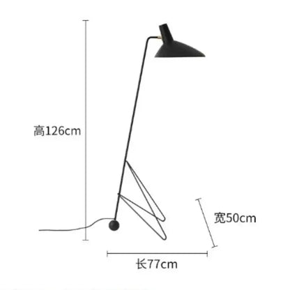 Minimalist black metal tripod desk lamp with sleek angular design and curved arm for bedroom or office use