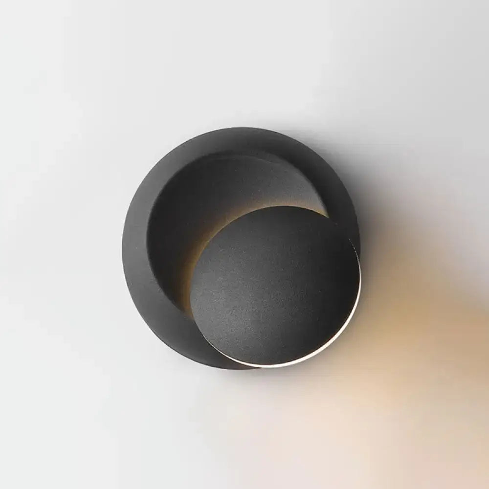 Minimalist black moon shaped sconce lighting with matte finish designed as a bedroom wall lamp