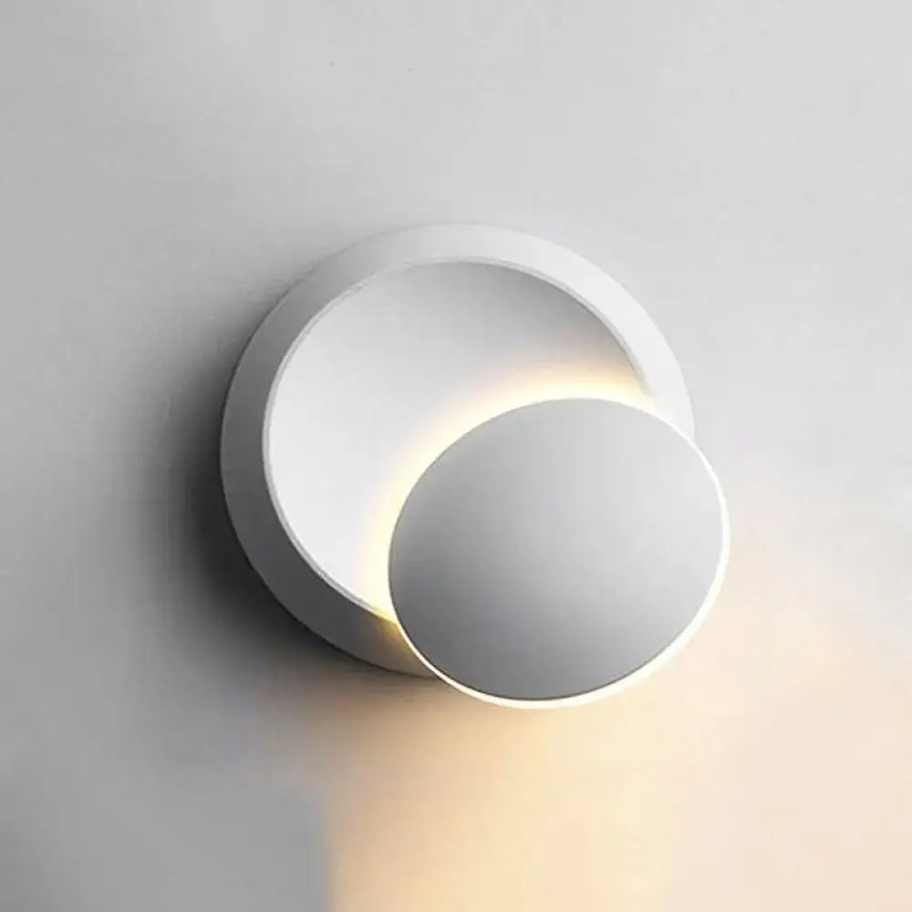 Modern white circular moon shaped sconce lighting with minimalist design and warm ambient bedroom wall lamp