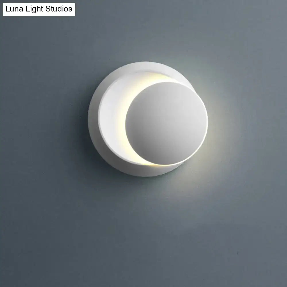 White crescent moon shaped sconce lighting with smooth minimalist design and soft ambient bedroom wall lamp