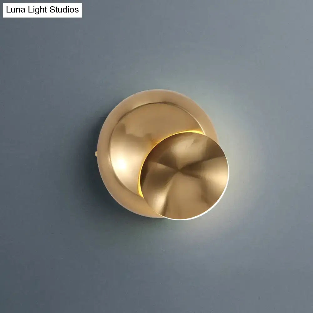 Brass-finished minimalist moon shaped sconce lighting with overlapping circular discs for bedroom wall lamp