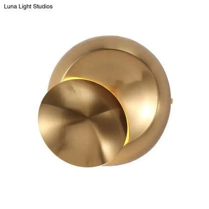 Minimalist black moon shaped sconce lighting with brass finish and warm ambient light for bedroom wall lamp