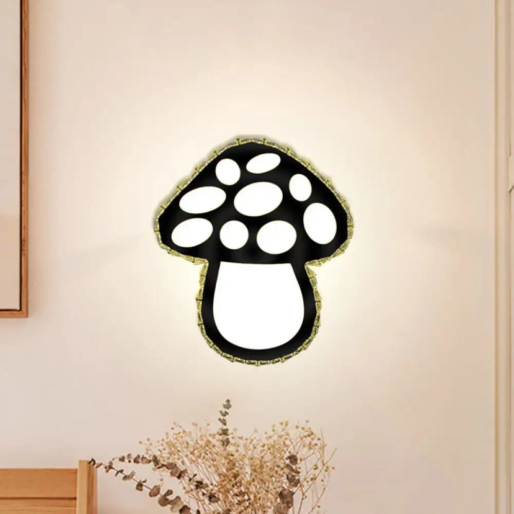 Minimalist black mushroom led wall sconce with glowing white interior and decorative green trim for bedroom accent lighting