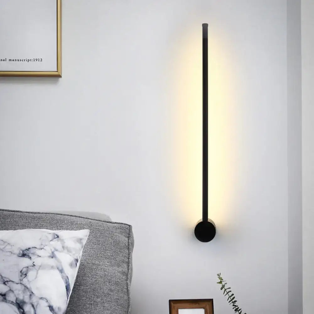Minimalist black needle wall light with sleek cylindrical design and warm ambient lighting for 110v-120v wall light bulb base