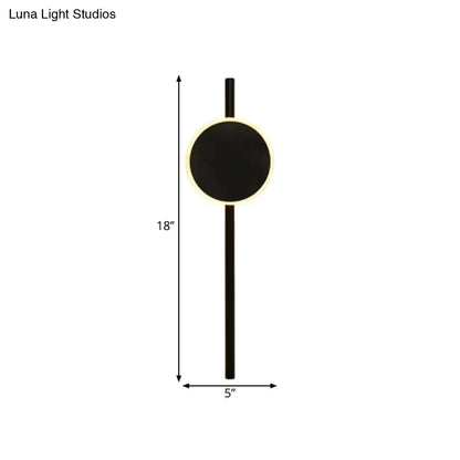 Black circular minimalist nordic led flush wall sconce with glowing led ring and slim vertical stem for bedroom use