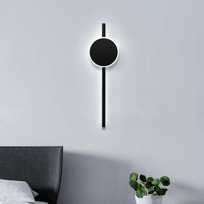 Modern black nordic led flush wall sconce with circular face and vertical rod featuring minimalist design for bedroom lighting