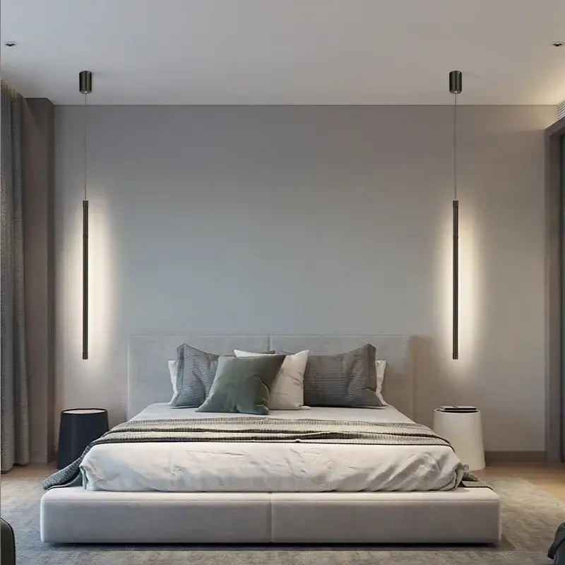 Modern minimalist bedroom with sleek upholstered bed and two slender decorbites black nordic led pendant lights above