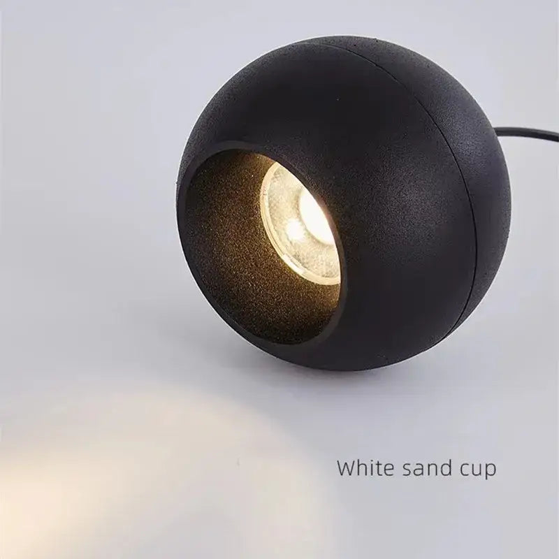 Minimalist black spherical pendant light with warm glow featuring die-cast aluminum and acrylic lamp holder for kitchen use