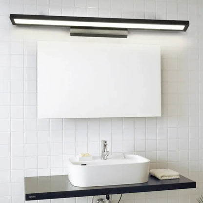 Minimalist black and silver bathroom vanity lamp with sleek rectangular design and metallic mounting bracket for bathroom vanity