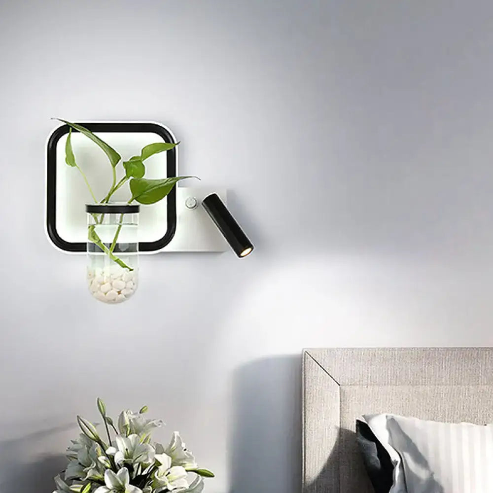 Modern black and white wall mount light with glass plant pot and greenery for minimalist bedroom sconce
