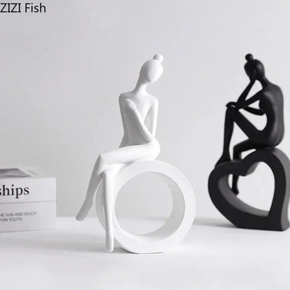 White ceramic figurine of seated woman hair in bun on circular base minimalist decorbites abstract resin sculpture
