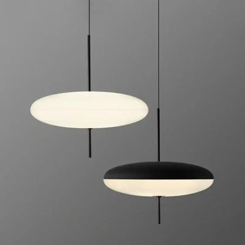 Minimalist black and white acrylic pendant light with sleek rods and circular shades for dining room use