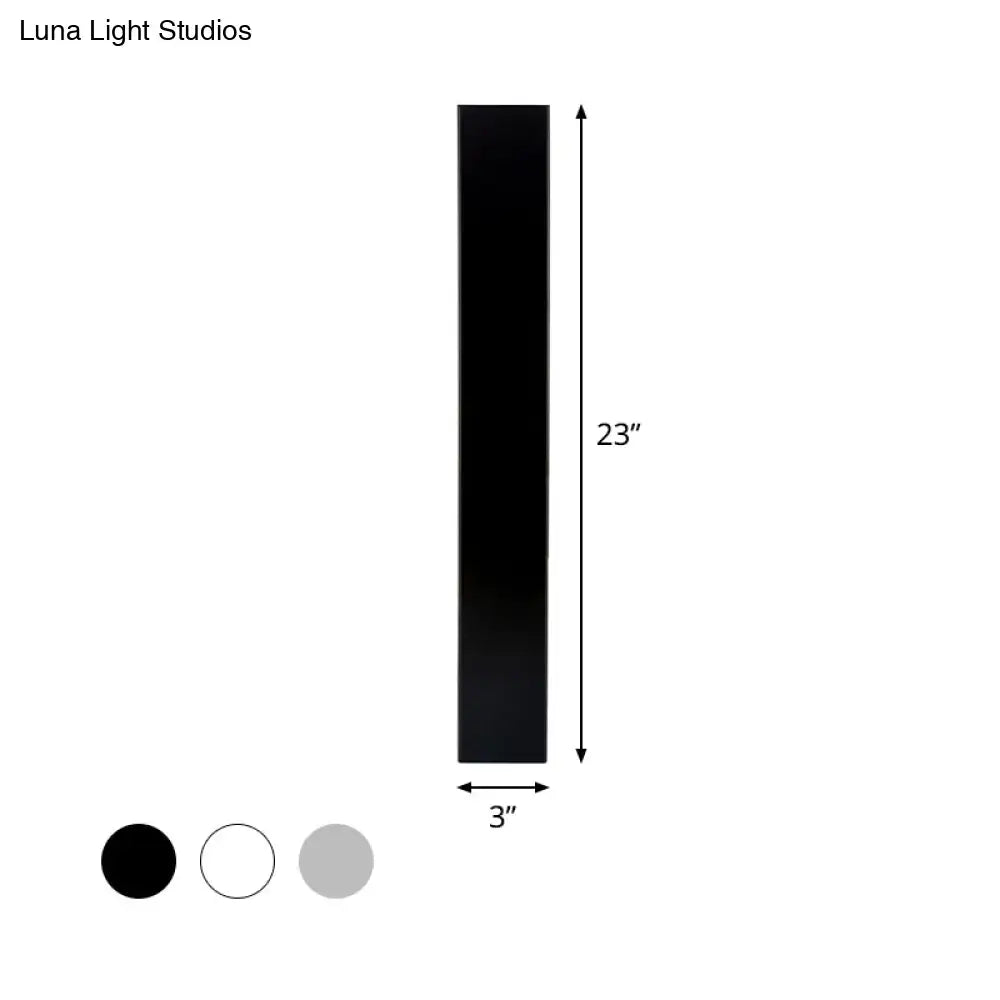 Minimalist black rectangular aluminum shade direct wired sconce measuring 23 inches tall and 3 inches wide for bedroom use