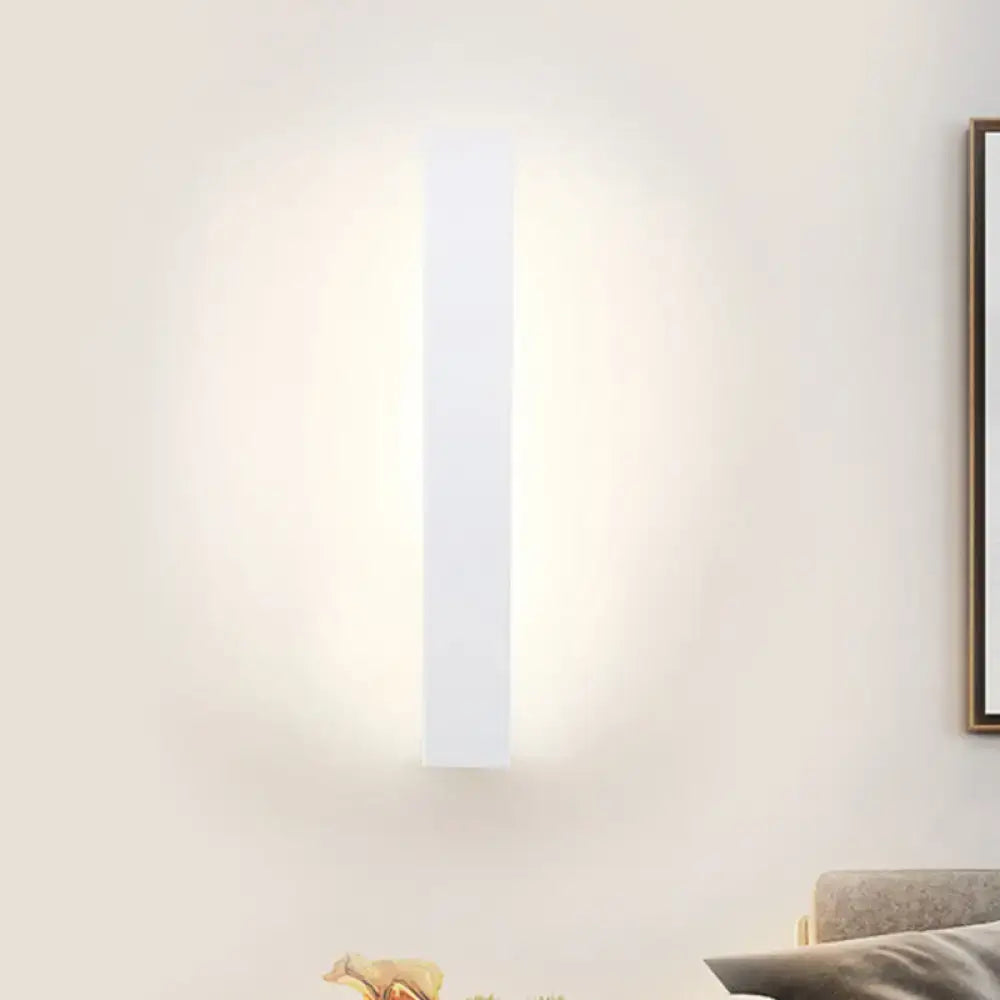 Modern white rectangular direct wired wall sconce with a minimalist black and white aluminum shade for bedroom use
