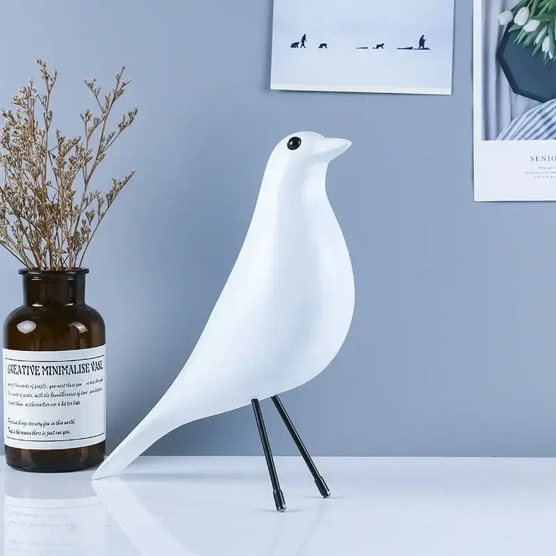 White ceramic bird peace dove resin craft with black metal legs and single black eye minimalist decorbites bird peace