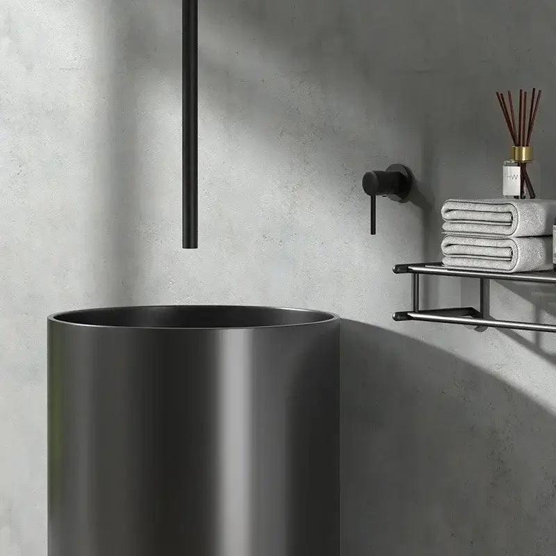 Black matte-finished cylindrical vessel sink paired with minimalist black and white ceiling faucet bathroom mixer