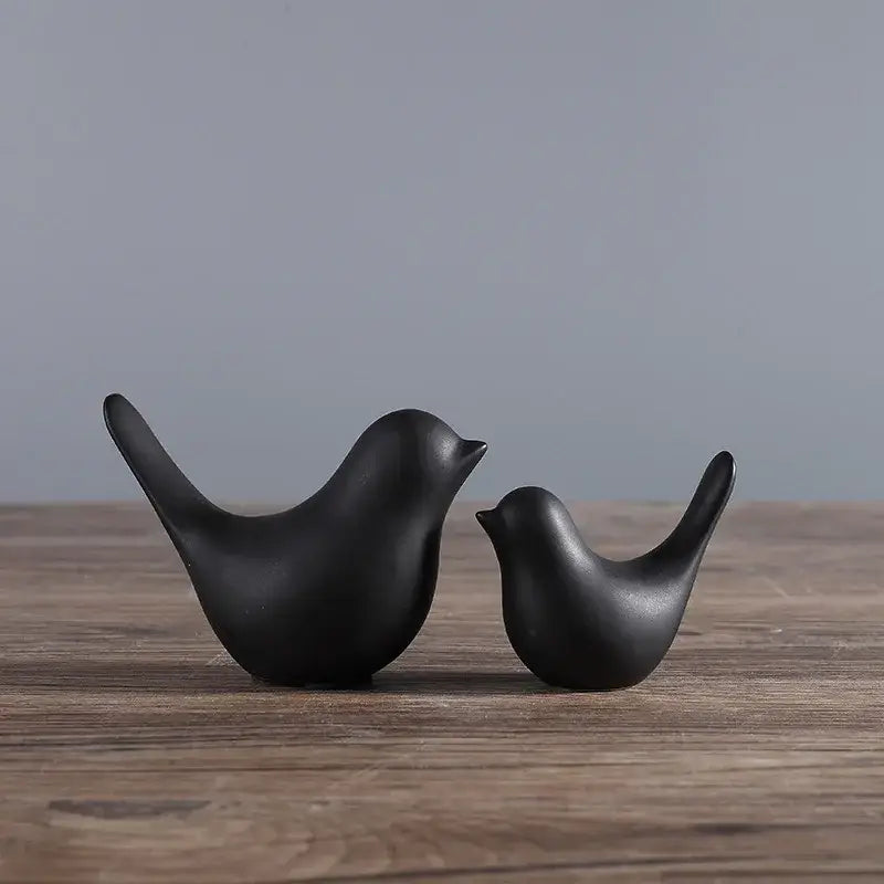 Minimalist black ceramic bird figurine set with smooth glossy surfaces for elegant living room decor