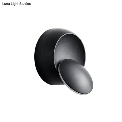 Matte black minimalist wall lamp with overlapping circular led design in black and white for stairway lighting
