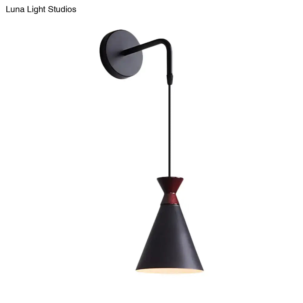 Minimalist black iron conical wall light with red accent band and matte finish mounted on adjustable curved arm