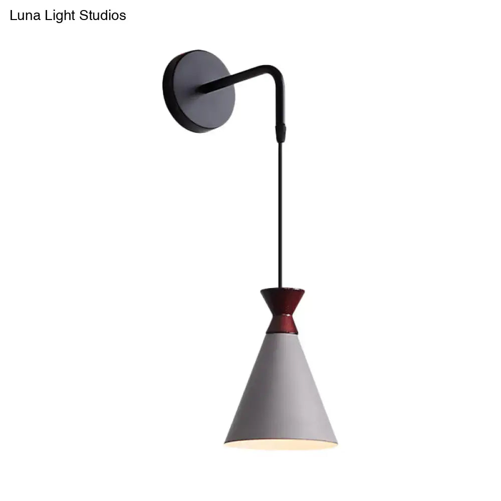 Minimalist black and white iron conical wall light with matte black base and red-accented gray shade for bedroom use