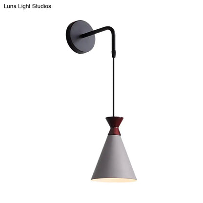 Minimalist black and white iron conical wall light with matte black base and red-accented gray shade for bedroom use