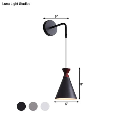 Minimalist black matte iron conical wall light with red accent on adjustable curved arm for bedroom use