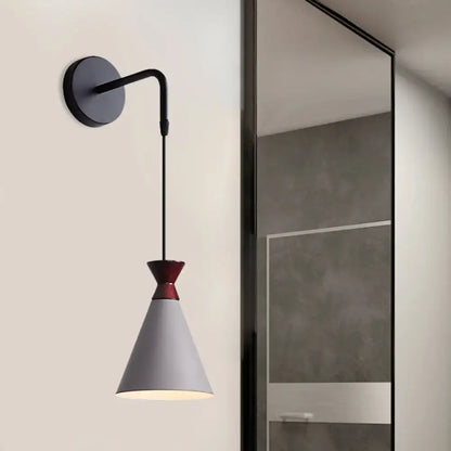 A minimalist black iron conical wall light with a gray lampshade and red band for bedroom use wall light