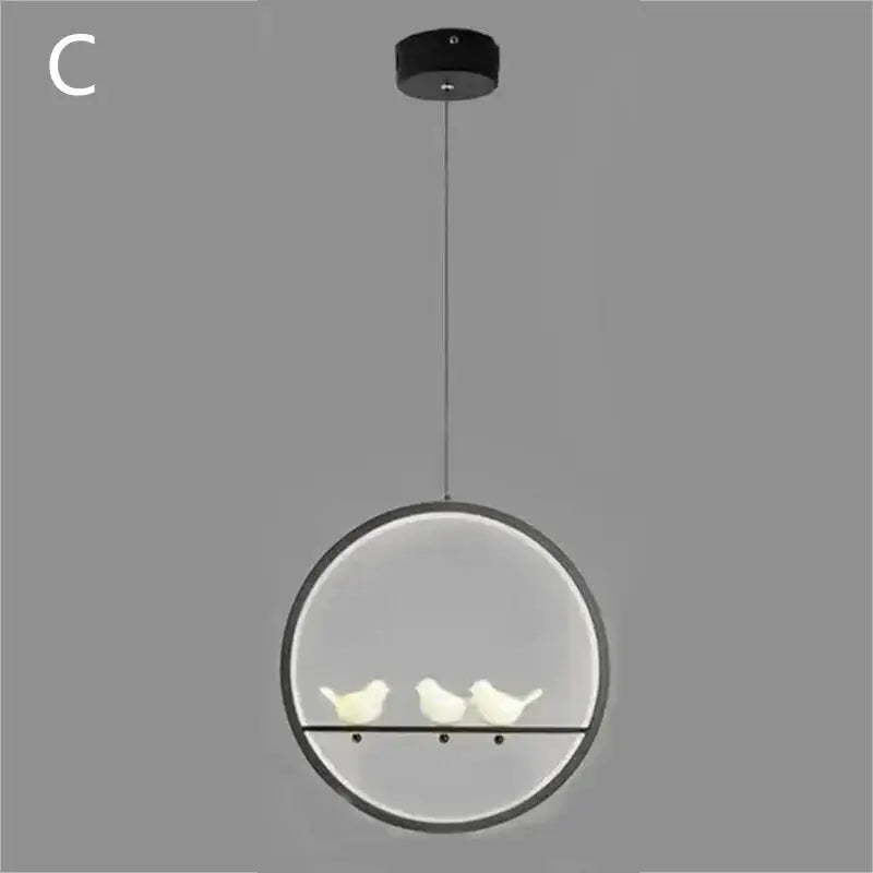 Modern circular pendant light with black frame and three white ceramic birds in decorbites bird chandelier design