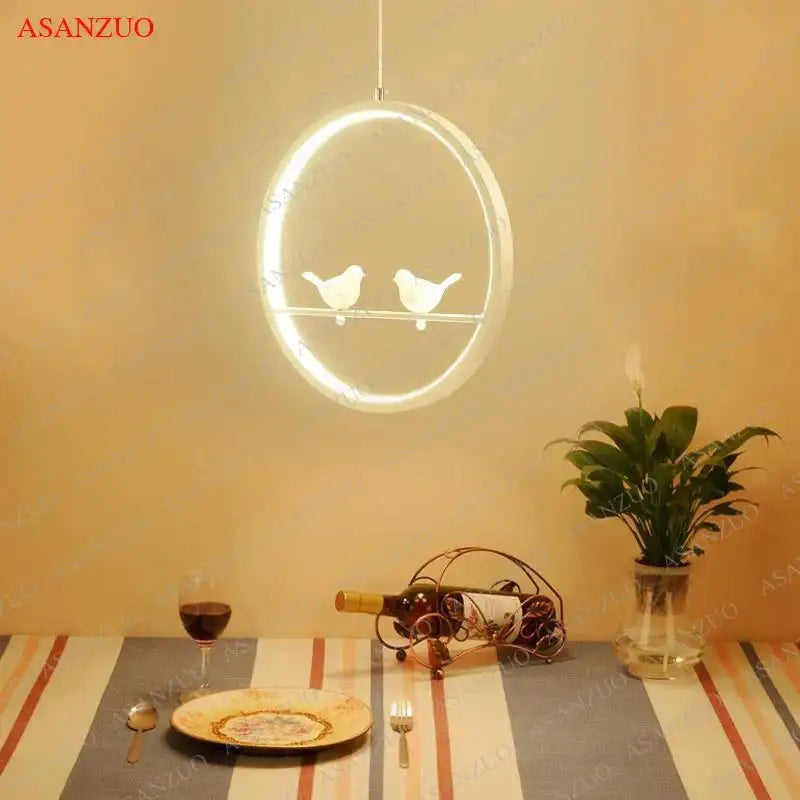 Minimalist black and white decorbites bird chandelier with circular led pendant light and two stylized birds for dining room