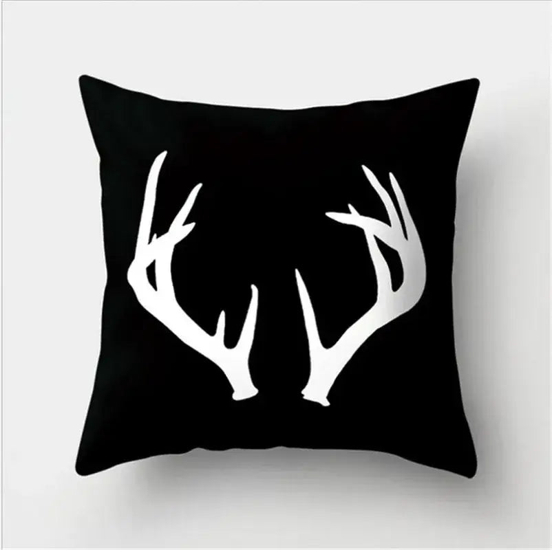 Black throw pillow with bold white deer antlers silhouette featuring black white flocking for living room decorbites decor