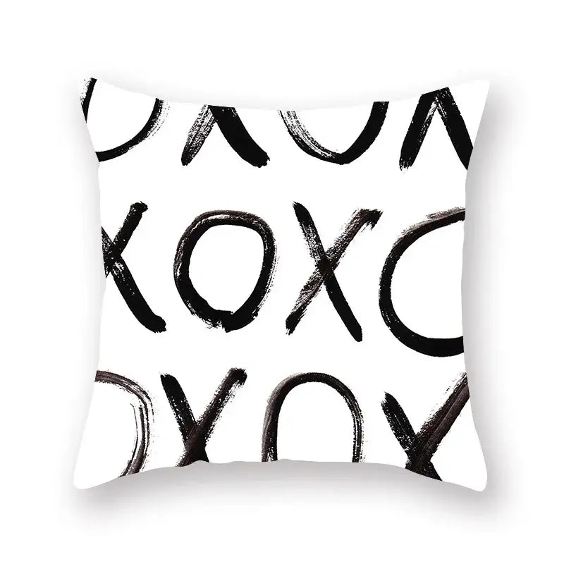 White throw pillow with bold black xoxo brushstroke pattern minimalist decorbites black geometric cushion cover