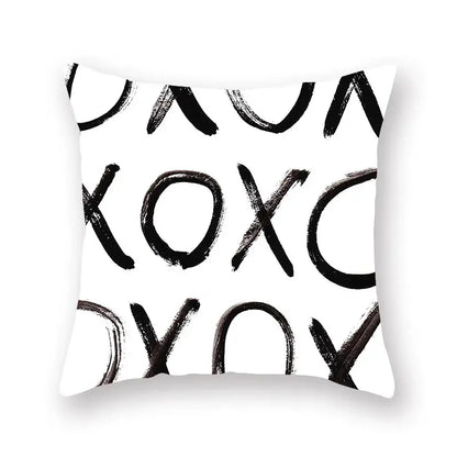 White throw pillow with bold black xoxo brushstroke pattern minimalist decorbites black geometric cushion cover