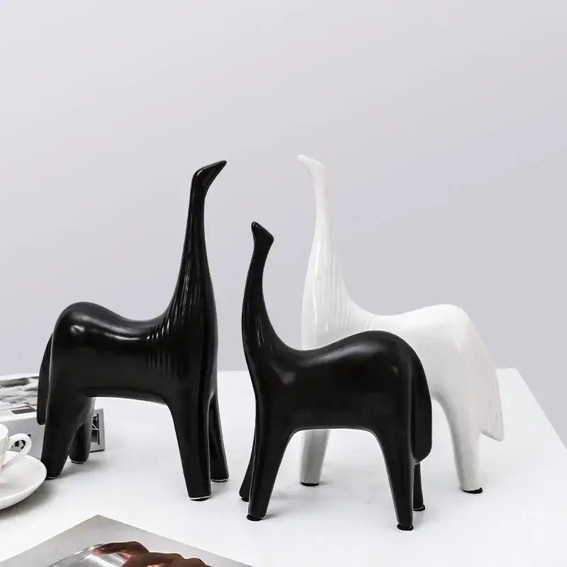 Two minimalist black and white ceramic horse abstract ornaments with elongated necks for stylish home decor