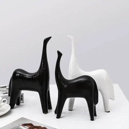 Two minimalist black and white ceramic horse abstract ornaments with elongated necks for stylish home decor