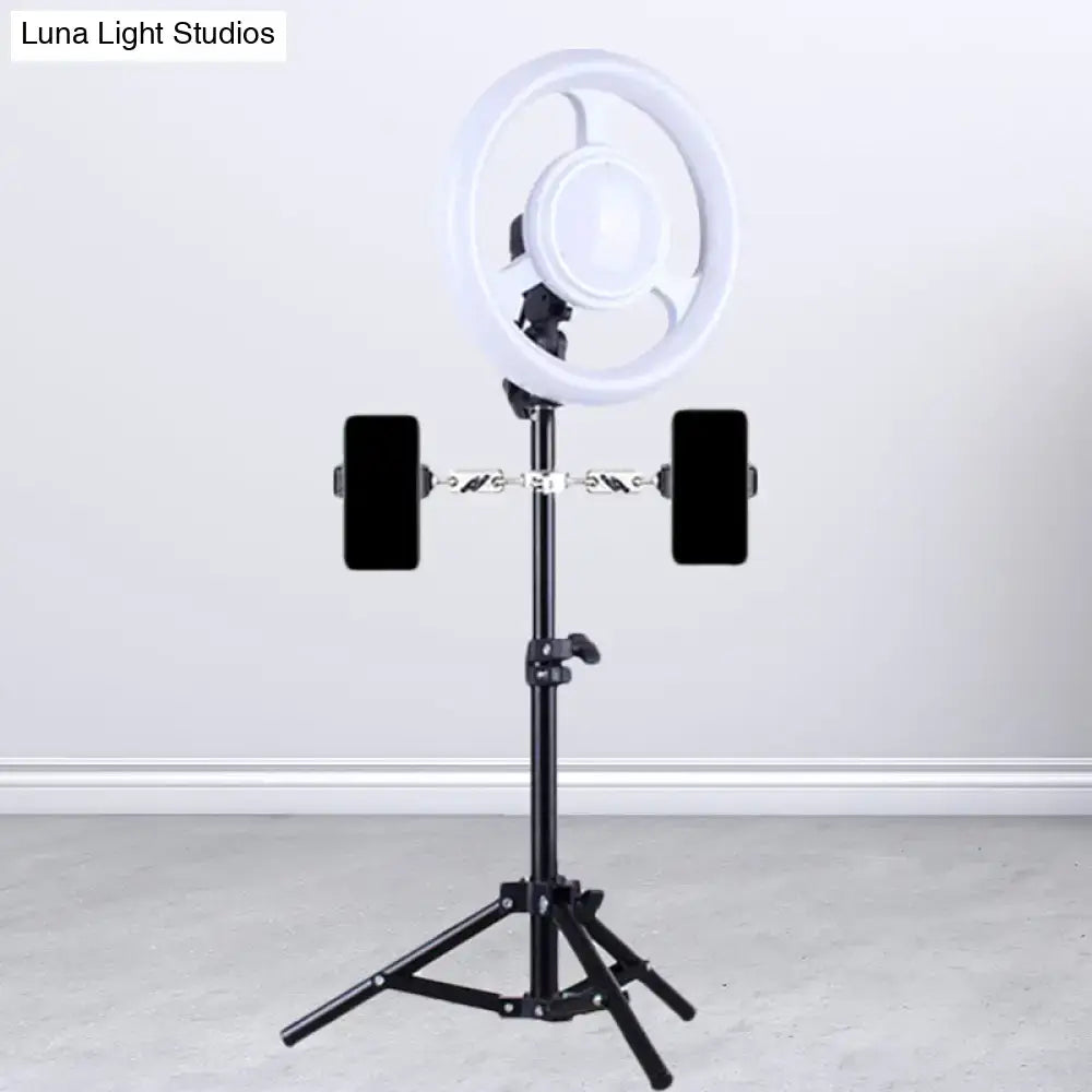 Minimalist black and white led ring light inch fixture with phone holder mounted on black tripod for bedroom use