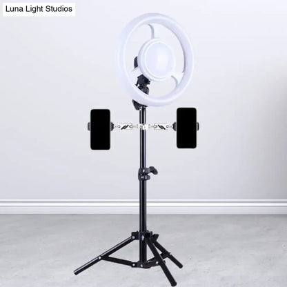 Minimalist black and white led ring light inch fixture with phone holder mounted on black tripod for bedroom use