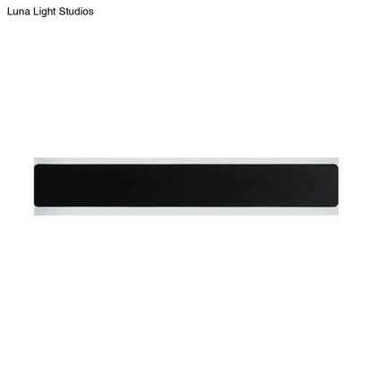 Black rectangular minimalist led wall lamp with white border designed as a bedroom sconce for contemporary decor