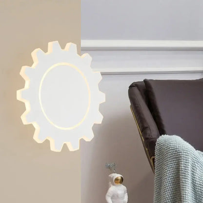 White gear-shaped led wall sconce with warm white light center for minimalist black white bedroom decor