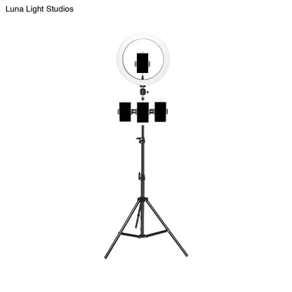 Minimalist black and white mobile phone holder with ring light mounted on tripod stand for bedroom use