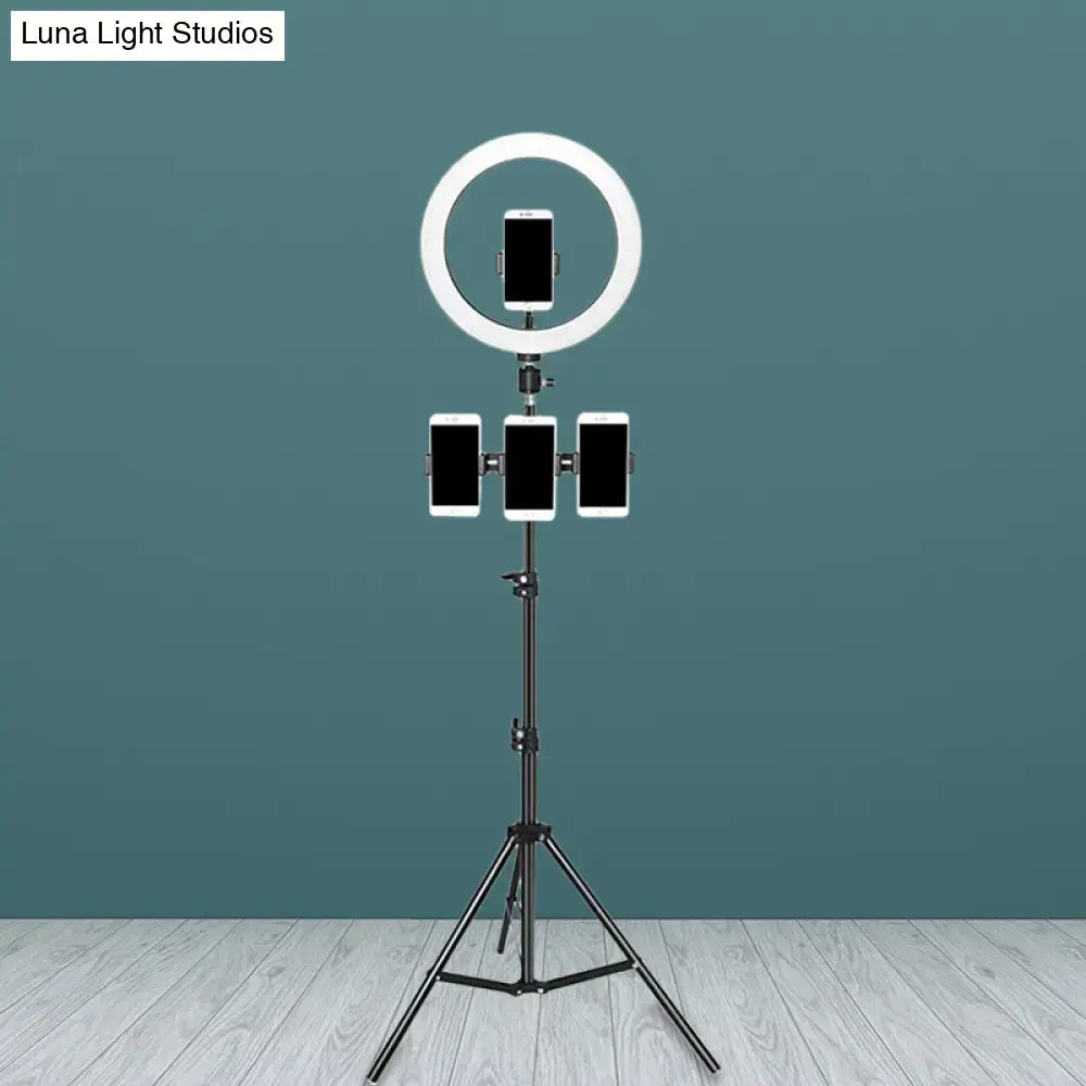 Minimalist black and white mobile phone holder with white led ring light and three phone holders on black tripod for bedroom