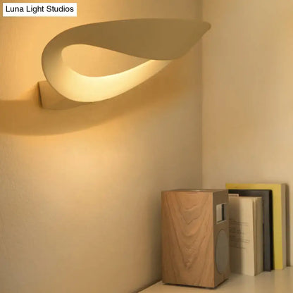 Cream-colored minimalist oval wall sconce with integrated led bulb sleek modern wall light for bedroom use