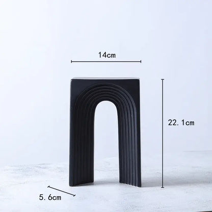 Black ceramic semicircular arch bookend with sleek vertical ridges for minimalist living room decorbites geometric ceramic display