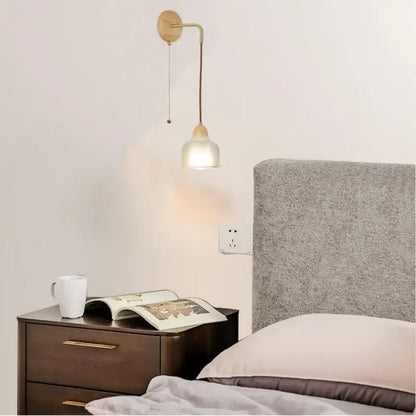 Minimalist wall light with brass arm wooden base and frosted clear glass shade for warm bedroom decorbites clear glass lighting