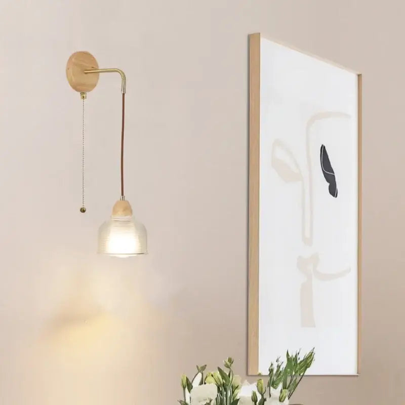 Minimalist brass wall light with clear glass frosted shade wooden base and pull chain switch by decorbites clear glass
