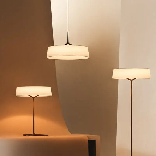 Modern minimalist dama pendant lamp and floor lamps with sleek brass frames and off-white fabric shades for kitchens