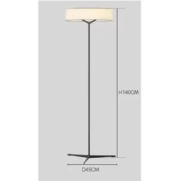 Modern black metal floor lamp with a wide off-white cylindrical shade complementing minimalist dama pendant lamp for kitchens