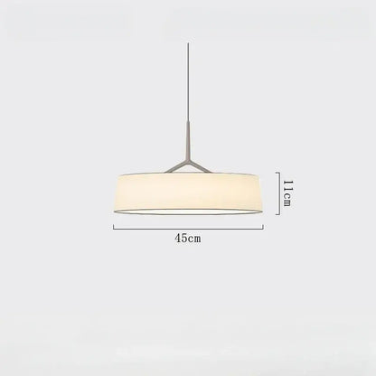 Minimalist brass and white fabric dama pendant lamp with matte metal frame and off-white shade for kitchens