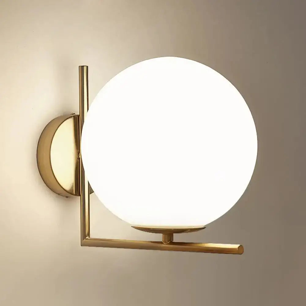 Minimalist brass angle arm wall sconce with gold-toned metal frame and frosted opaline glass globe for bedroom light e12 e14