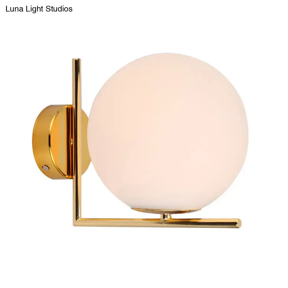 Minimalist gold finished spherical wall sconce with opaline glass globe and brass angle arm for e12 e14 bulbs
