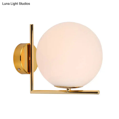 Minimalist gold finished spherical wall sconce with opaline glass globe and brass angle arm for e12 e14 bulbs